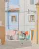An image of some houses, with washing hanging outside, by emerging Portuguese photographer Teresa Freitas.